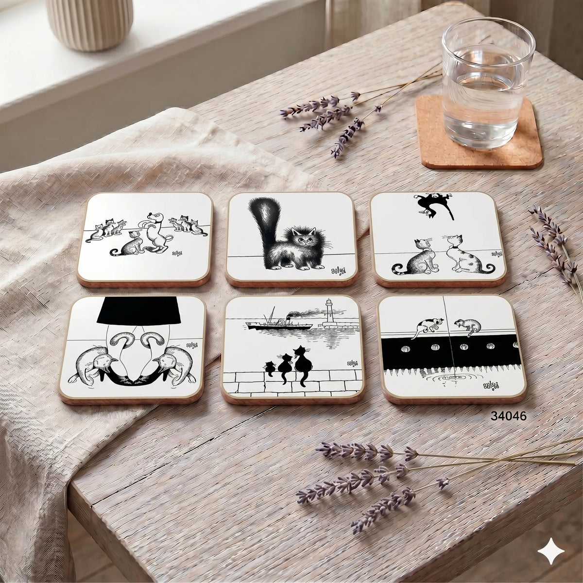 Set of six black and white coasters with illustrations on a wooden table with lavender.